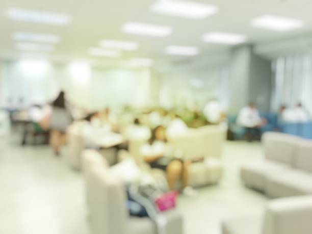 istock Education Concept: blurred image of students reading and working in modern library. Interior modern library background for relax and lift long learning in university. 951847542
