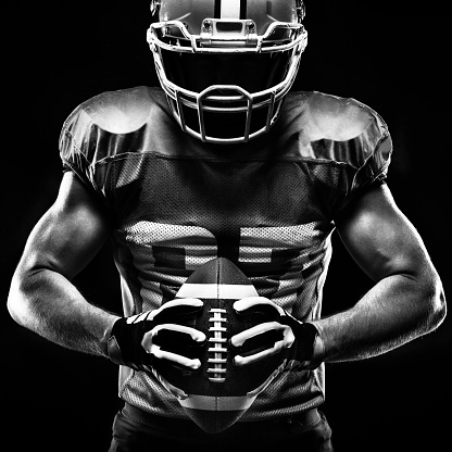 American football sportsman player on black background