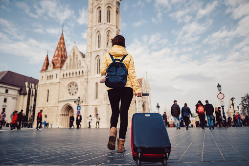 Young woman with suitcase at the castle hill-budapest