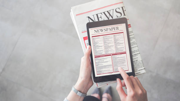 istock Person holding and reading news from tablet 951863978