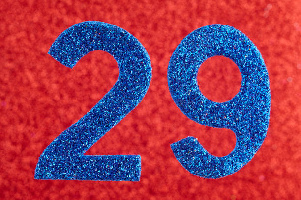 istock Number twenty-nine blue color over a red background. Anniversary. 951864238