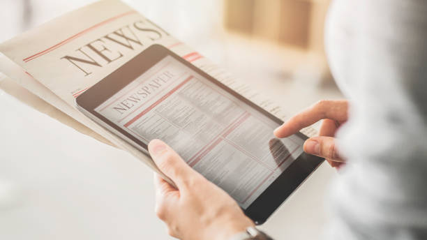 Person holding and reading news from tablet Person holding and reading news from tablet reading newspaper stock pictures, royalty-free photos & images