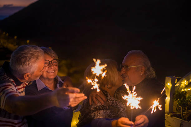 istock two adult couple celebrate with sparkles 951865708