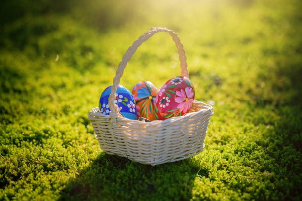istock Easter basket with traditional painted eggs in the grass. 951869742