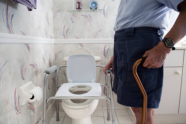 elderly man and handicap toilet stock photo