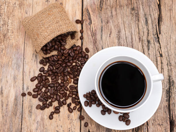istock fresh espresso coffee cup with coffee bean on wooden table. coffee background for cafe or coffee shop 951876484