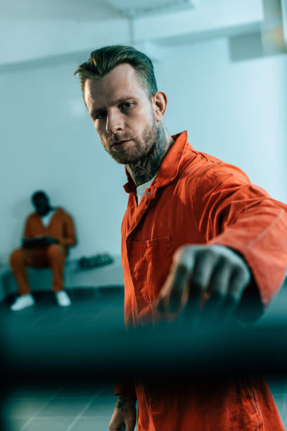 istock multiethnic prisoners in prison cell behind prison bars 951888332