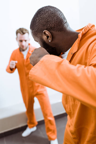 istock multiethnic prisoners fighting in prison cell 951889444