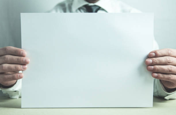 istock Businessman showing blank paper. 951889614
