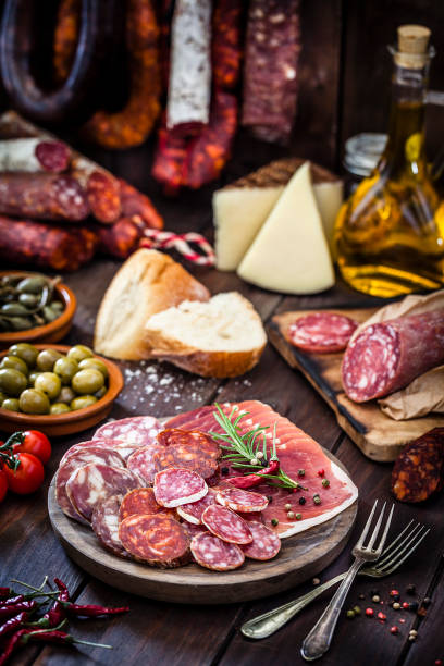 istock Mixed spanish chorizo slices plate on rustic wooden table 951890186