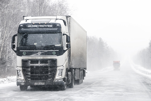 Chelyabinsk region, Russia - February 10, 2018: Semi-trailer truck Volvo FH at the interurban road during a heavy blizzard.