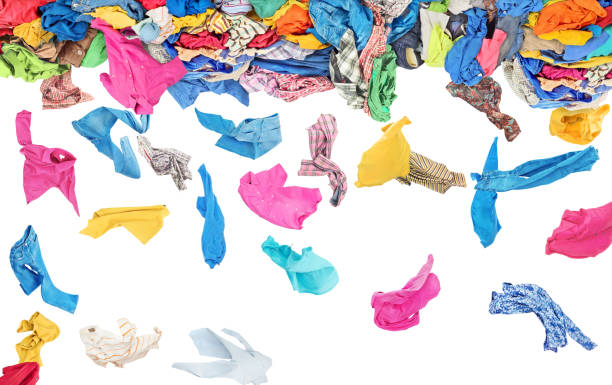 istock Separate clothing fall from a large pile of clothes on a white background 951896500