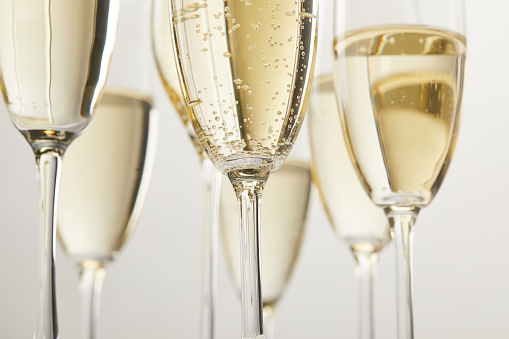 cropped image of champagne glasses with bubbles isolated on white background