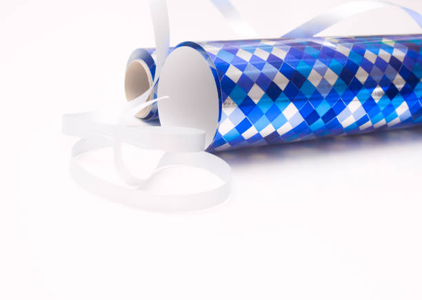 istock Rolls of blue gift wrapping paper with ribbons bows on white background 951901080