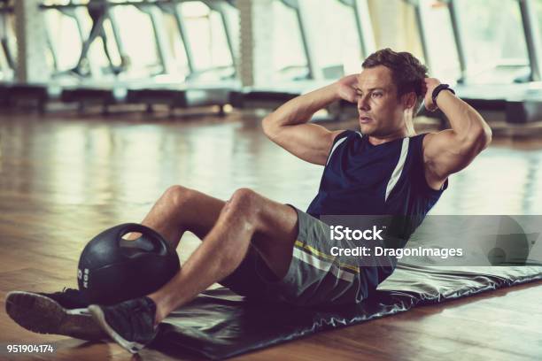 Doing Situp Stock Photo - Download Image Now - Sit-ups, Men, Exercising