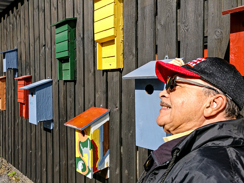 Stockholm, Sweden Portrait of man, 80 yrs old, with bird houses.