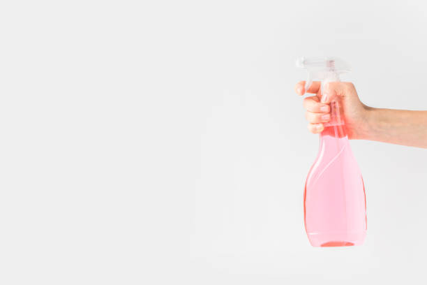 istock hand holding pink spray bottle 951917504