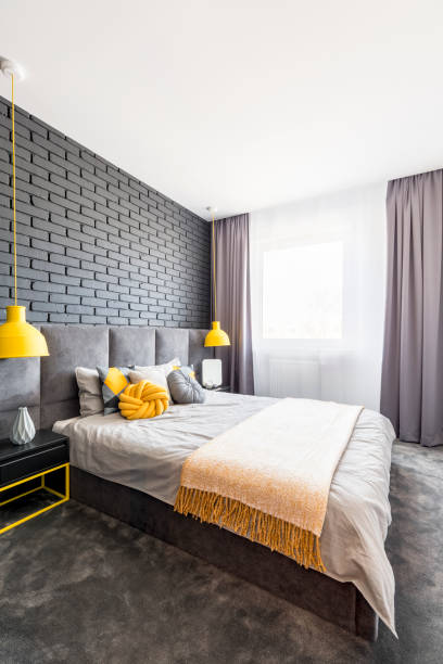 istock Gray and yellow bedroom interior 951917674