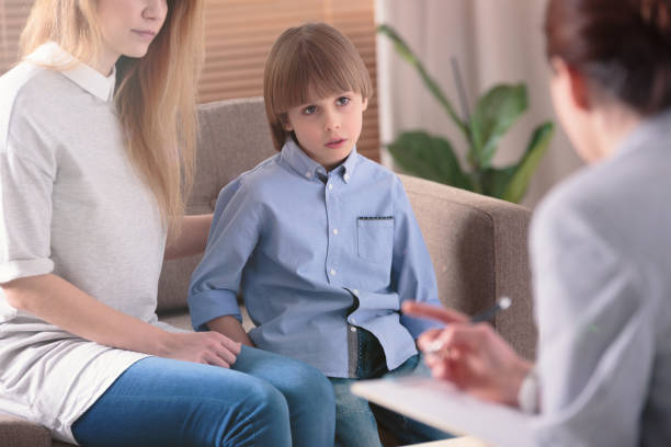 istock Autistic child listening to therapist 951921550