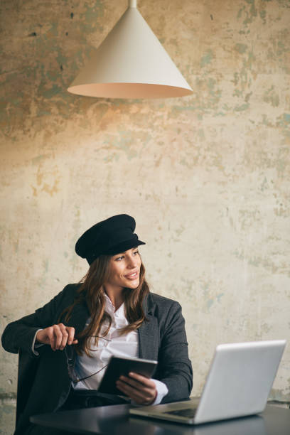 istock Young modern woman sitting in cafe and using tablet for work. 951921752