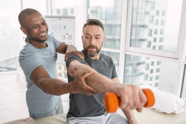 istock Delighted nice therapist smiling to his patient 951923344