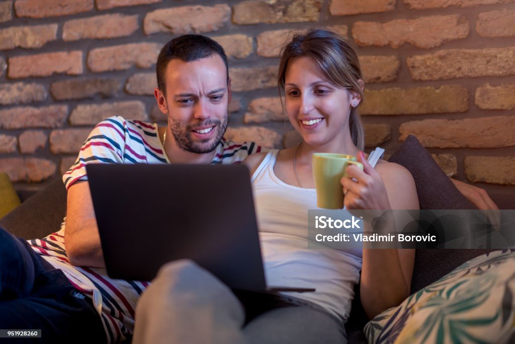 Computer Watching Images Young Couple Using Computer Watching Internet Content And Laughing ...