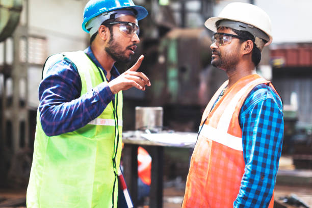 istock Two steel factory employees having a conversation 951929188