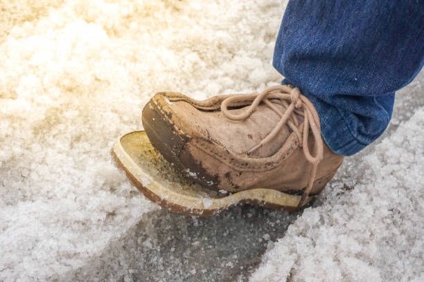 istock The torn shoes ,its torn while walking on the road that covered by snow 951930528