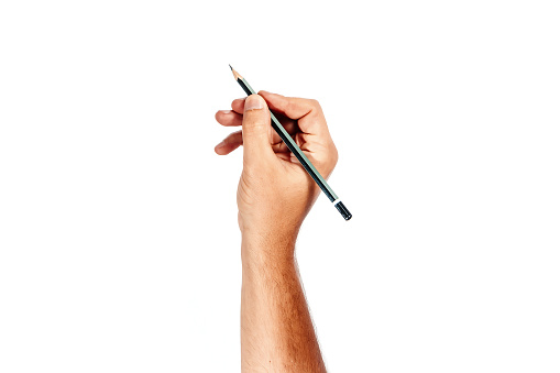 A man's hand holds a black pencil on a white background, isolate.