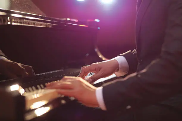 Close-up of a piano player performing