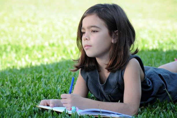 istock girl studying outdoors 951938186