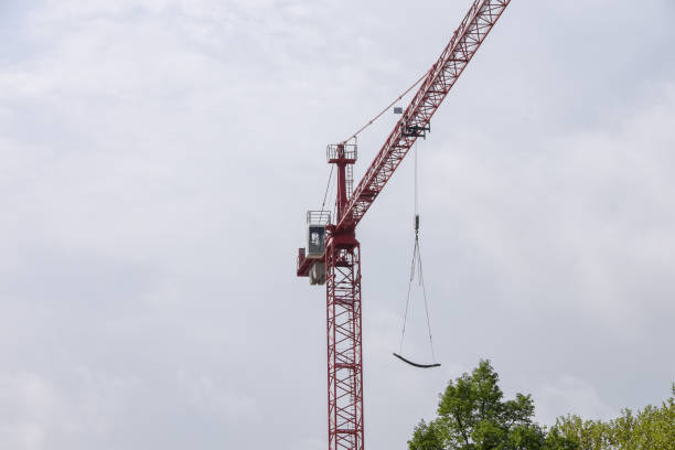 istock Crane on construction site carries long structural steel at high altitude 951946386