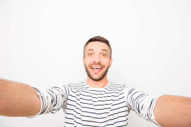 istock Happy cheerful handsome man making funny selfie 951946520