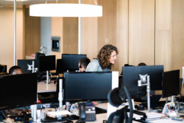 istock Colleagues discussing at desk in office 951947422