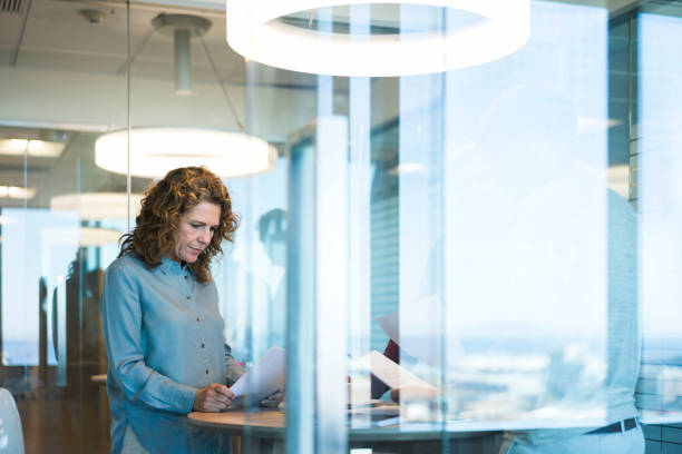istock Businesswoman reading document seen through glass 951948616