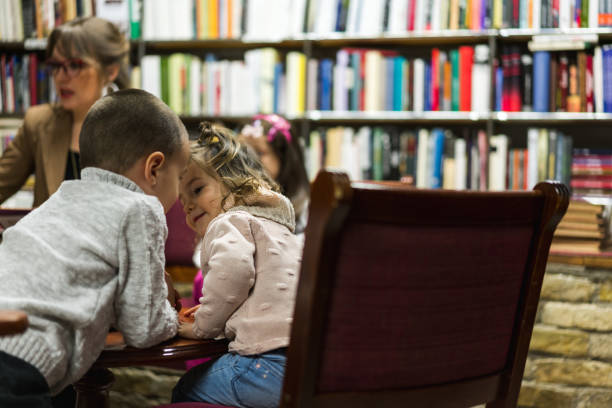 istock Kids in library listening to stories 951948736