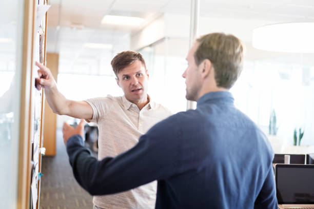 istock Businessman discussing with colleague in office 951951008