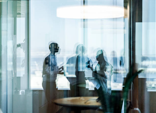 Business colleagues seen through glass at office