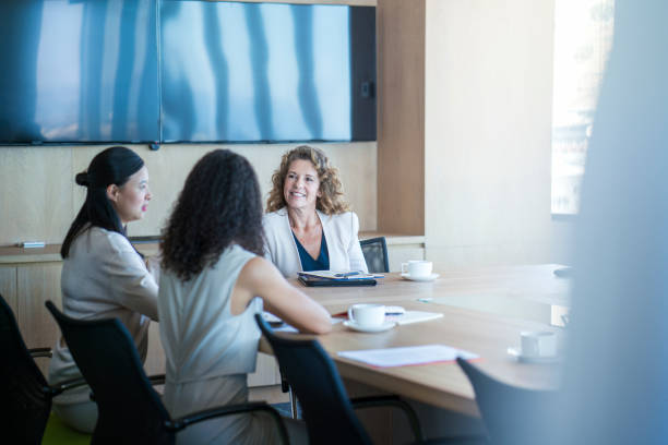 istock Businesswomen discussing at table in board room 951951378