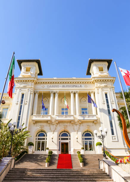 The Municipal Casino in San Remo, Liguria, Italy San Remo,Liguria, Italy - March 29, 2018: Palm trees in front of the Casino Municipale facade, famous theatre, gambling and entertainment complex located on the Italian Riviera. One of the main San Remo landmarks. art nouveau sun stock pictures, royalty-free photos & images