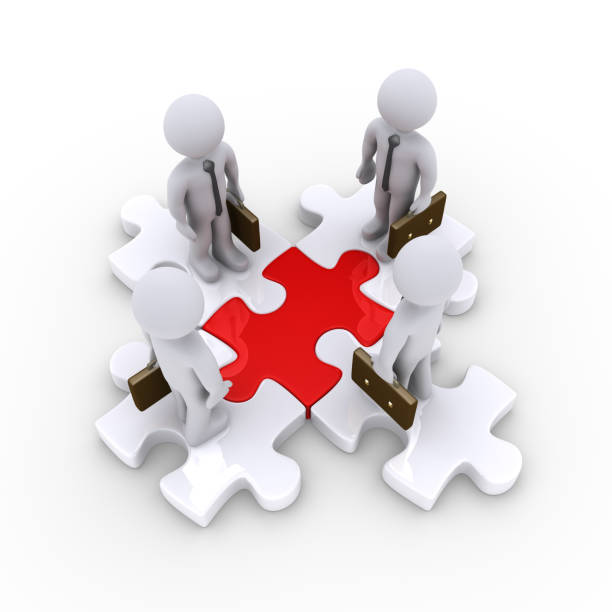 istock Businessmen on connected puzzle pieces 951952432