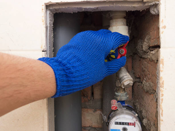 the plumber in safety blue gloves closes or opens the water valve at home. - water pipe vehicle part work tool pipe imagens e fotografias de stock