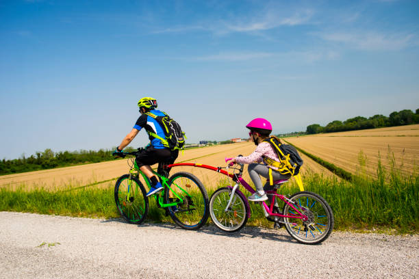Father and daughter going in bicycle