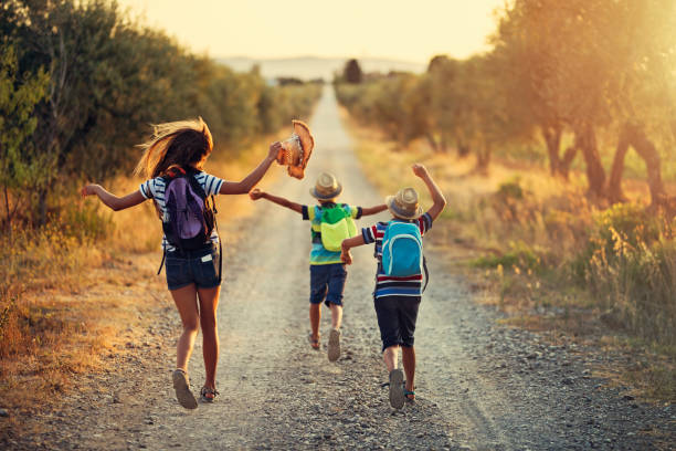 Three kids running on last day of school