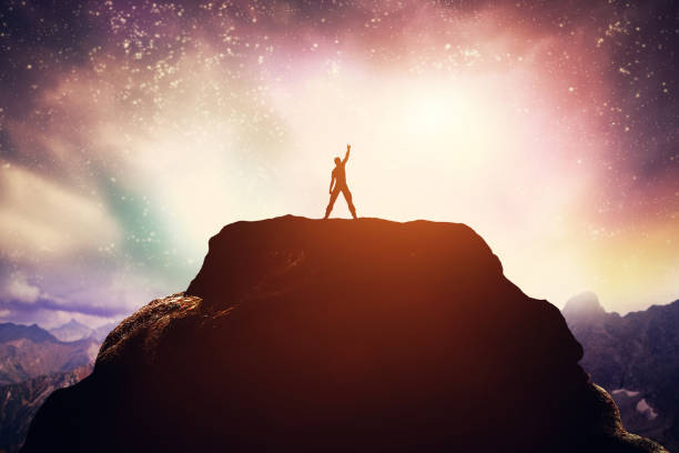 istock Excited man standing on the peak of a mountain. 951960314