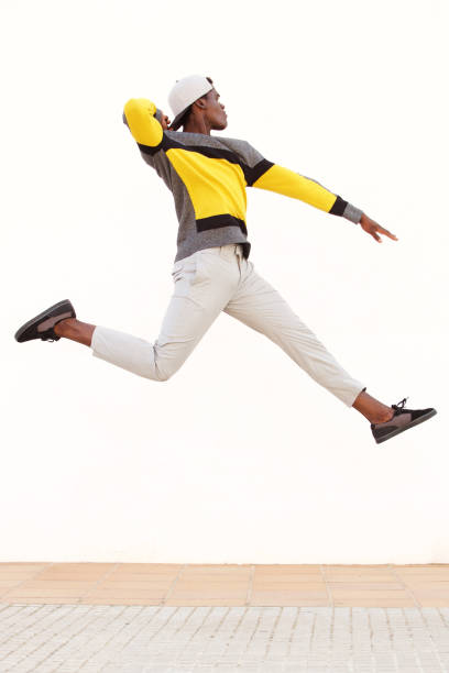 istock cool young african man jumping in air 951962222