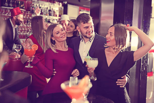 istock Guy with two girls partying in bar 951969612