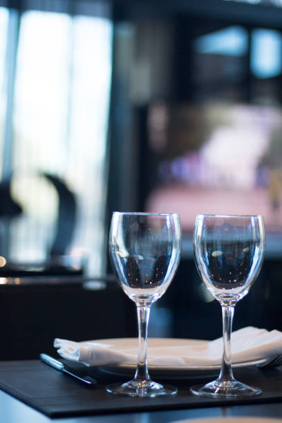 istock Restaurant cafe bar in luxury hotel with place settings for breakfast, lunch and dinner with wine water glasses 951972358