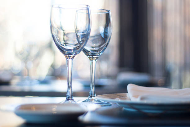 istock Restaurant cafe bar in luxury hotel with place settings for breakfast, lunch and dinner with wine water glasses 951972362