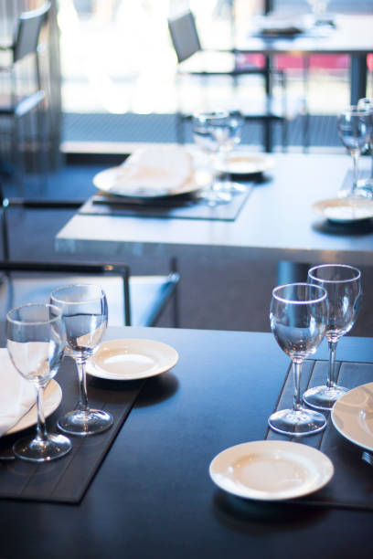 istock Restaurant cafe bar in luxury hotel with place settings for breakfast, lunch and dinner with wine water glasses 951972494